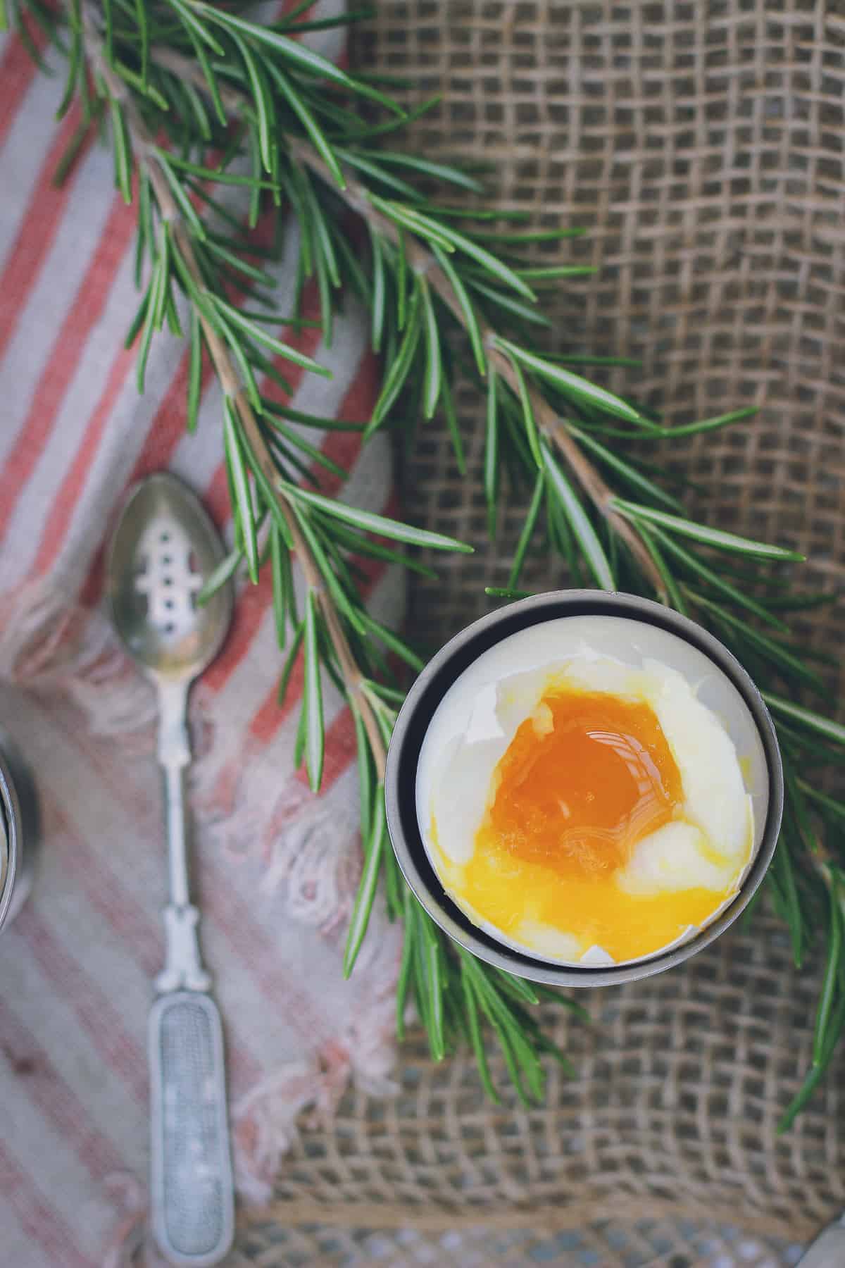 This is a photo of a soft-boiled egg shot from above. It showcases the rich, golden, soft and runny yolk and the set white.
